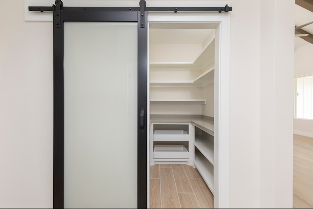 Walk-in pantry with black barn door